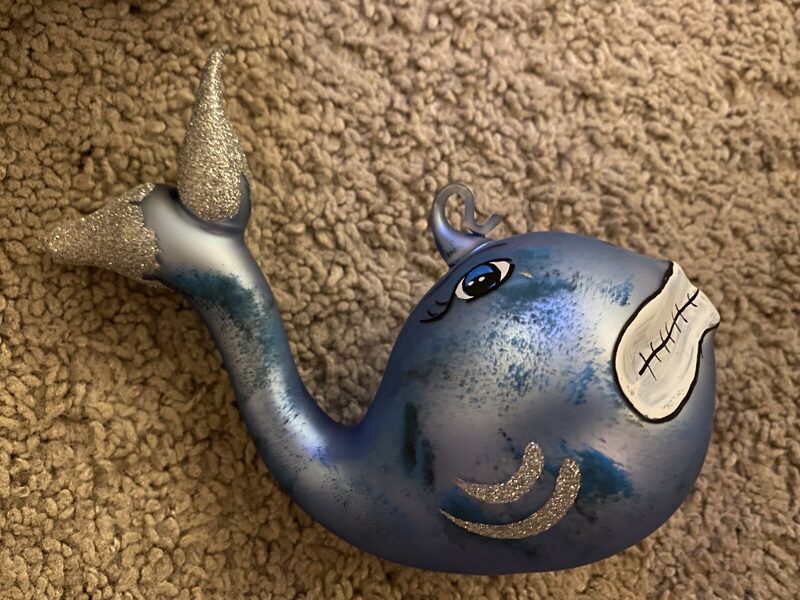 A blown-glass blue whale ornament with glitter detailing
